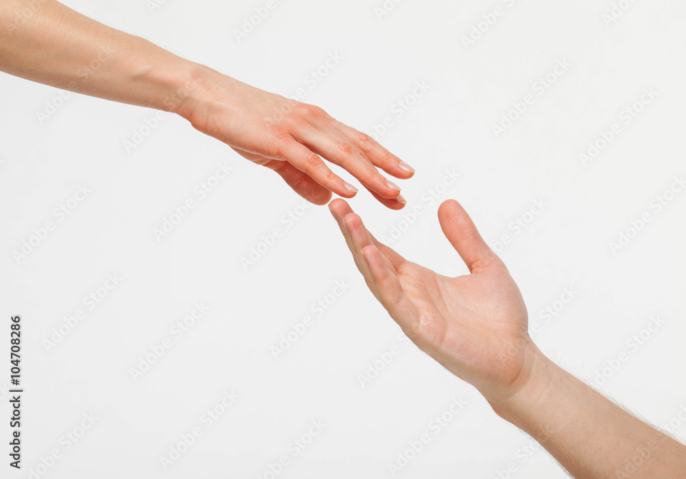 Hands of man and woman reaching out to each other