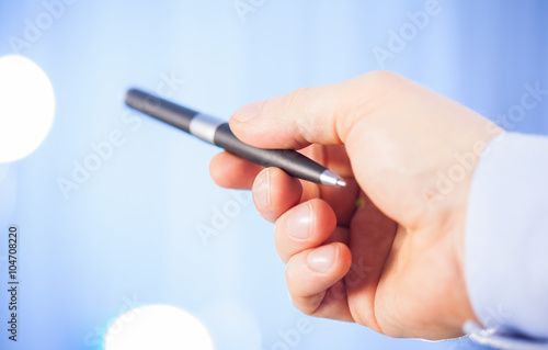 Businessman s hand holding a pen