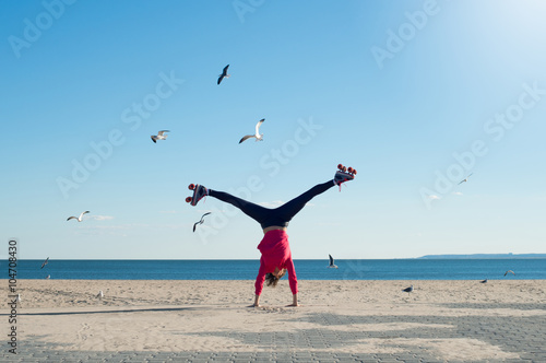 Young woman doing cartwheel photo
