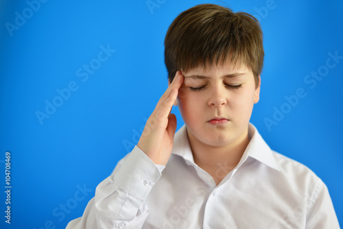 Portrait of teenage boy with a headache
