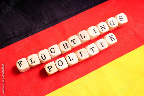Flüchtlingspolitik, Buchstabenwürfel auf Deutschlandfahne