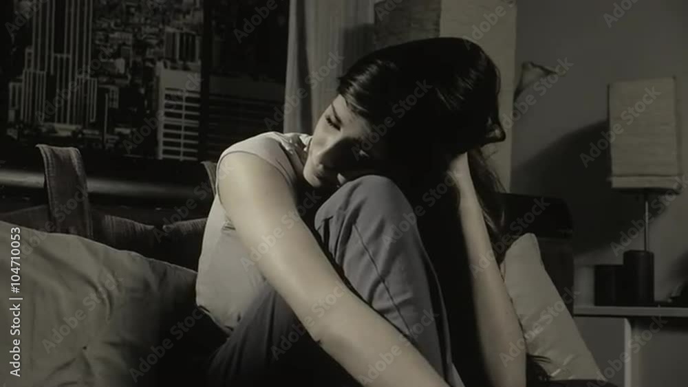 Sad lonely girl sitting on bed feeling heart broken slow motion Sad lonely girl sitting on bed feeling heart broken slow motion