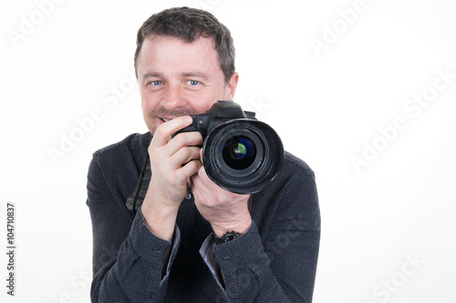 Happy man with camera. Isolated over white background.