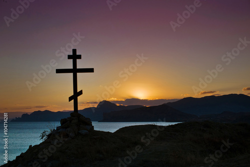 Cross silhouette on sunset