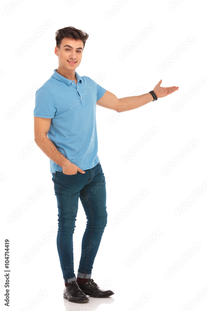 man in blue shirt presenting with hand in pocket man in blue shirt presenting with hand in pocket