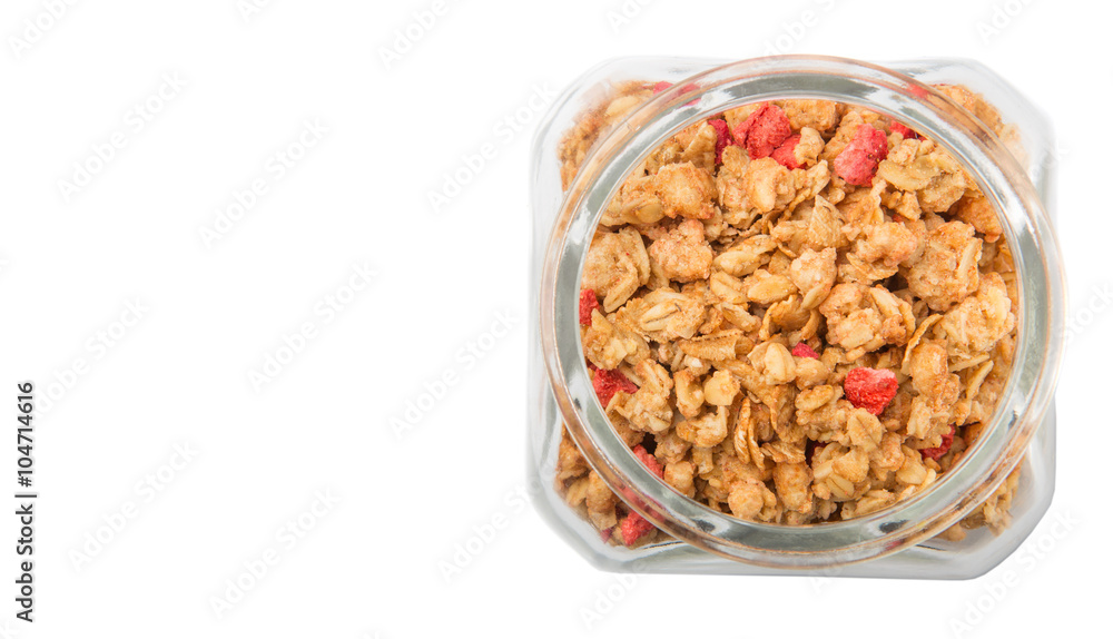 reakfast cereal with dried raspberry fruit pieces in glass jar over white background reakfast cereal with dried raspberry fruit pieces in glass jar over white background