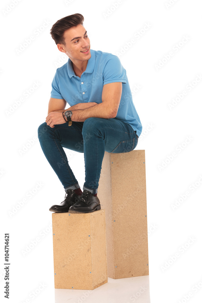attractive hipster seated on boxes attractive hipster seated on boxes