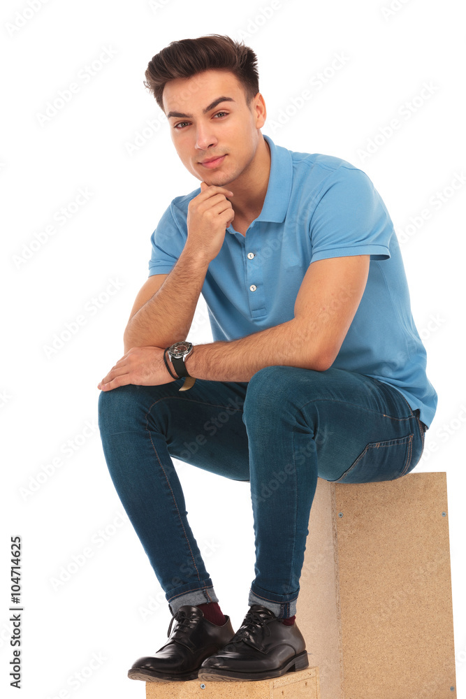 attractive boy seated on box attractive boy seated on box