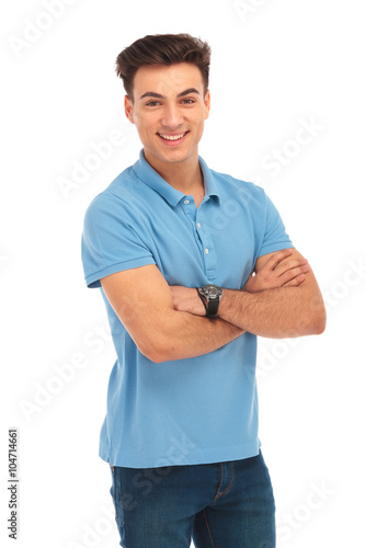 young man in blue shirt posing with arms crossed