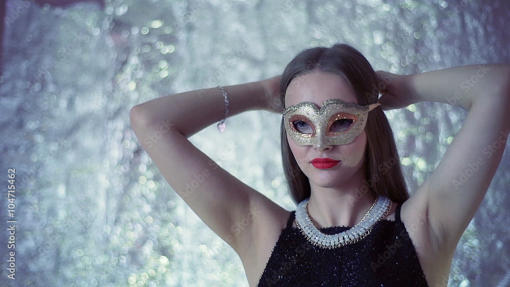 Beautiful girl putting goldwn mask on her face and tie it
Beautiful girl putting goldwn mask on her face and tie it
