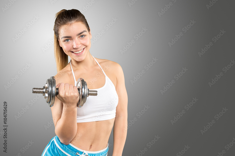 sporty muscular female wearing sports clothes working out with dumbbell sporty muscular female wearing sports clothes working out with dumbbell