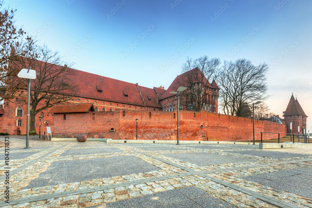 The Castle of the Teutonic Order in Malbork at sunset, Poland The Castle of the Teutonic Order in Malbork at sunset, Poland