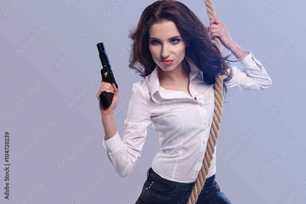 Young sexy Woman holding Handgun in hand Young sexy Woman holding Handgun in hand
