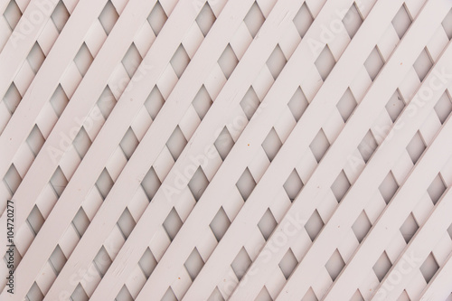 Wooden fence lattice pattern.