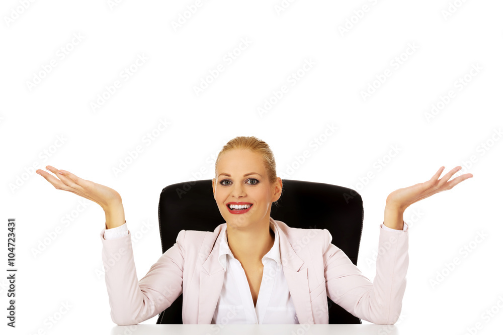 Business woman sitting behind the desk and making don't know sing Business woman sitting behind the desk and making don't know sing
