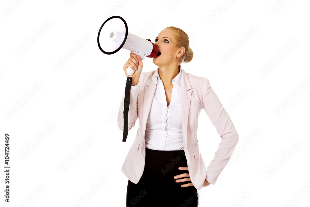 Young business woman screaming through megaphone Young business woman screaming through megaphone