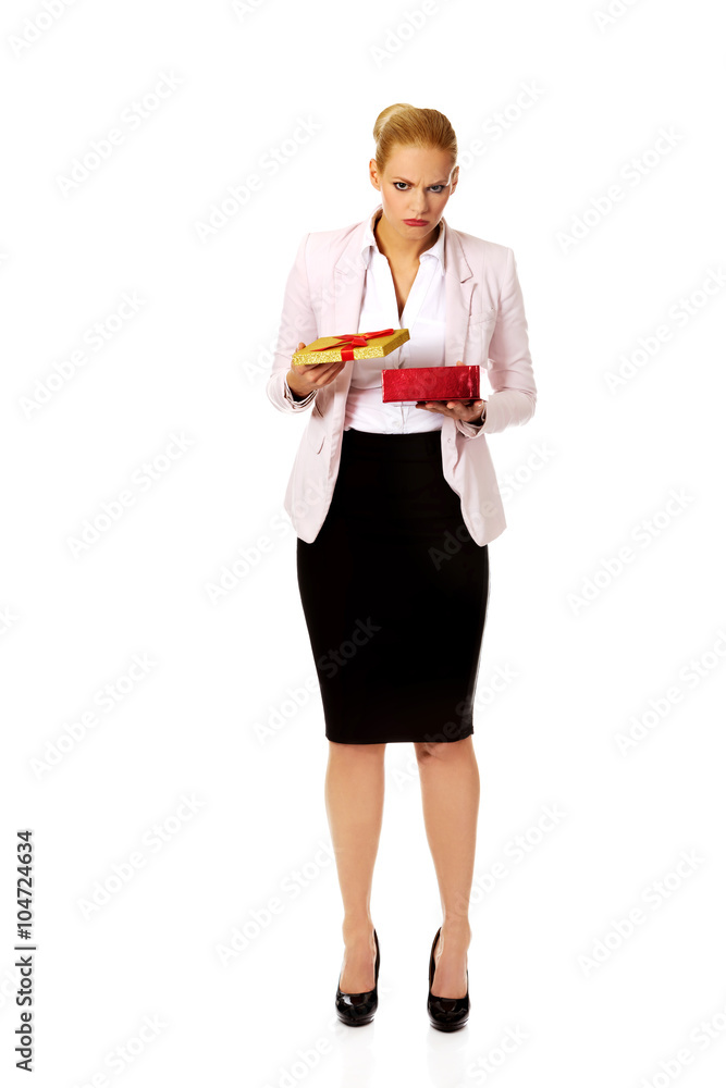 Upset business woman opening present box Upset business woman opening present box