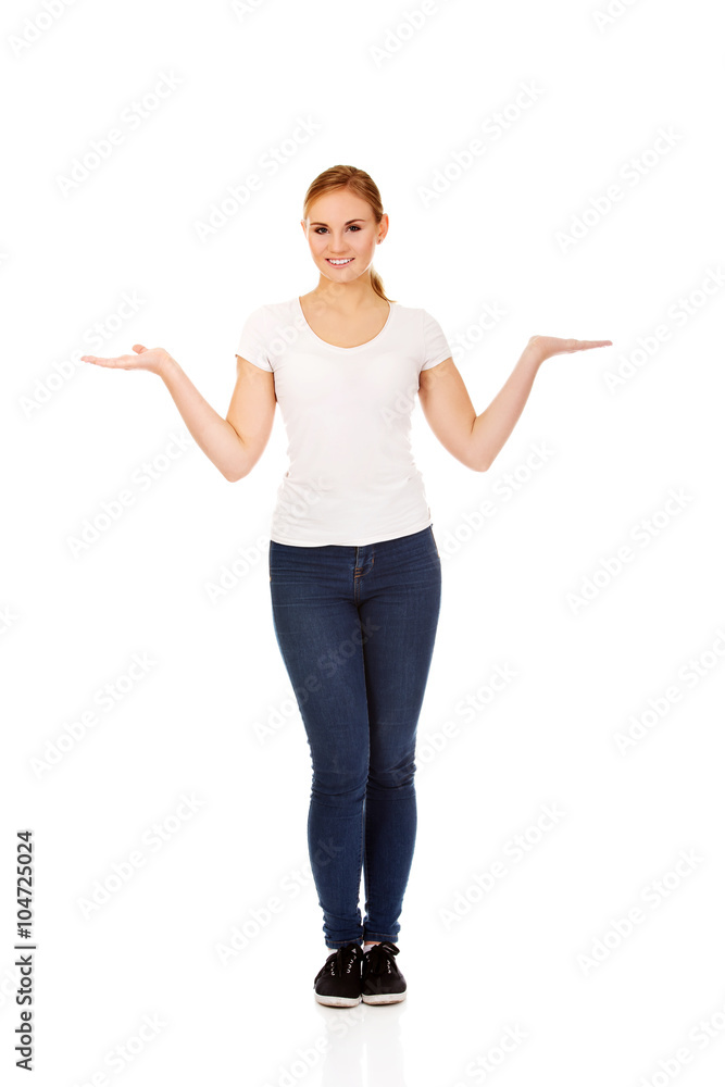 Young woman presenting something on open palms Young woman presenting something on open palms