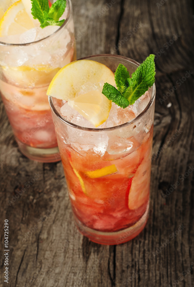 Cranberry cocktail with ice, mint, lemon and apple