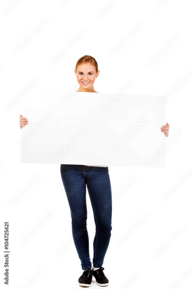 Happy young woman with blank billboard Happy young woman with blank billboard