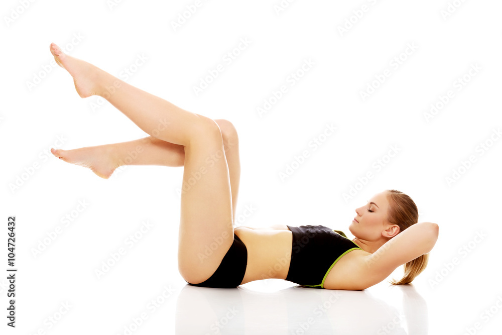 Young woman doing stretching exercise on the floor