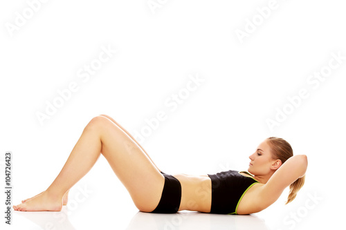 Woman exercising and doing a crunch to work her abs