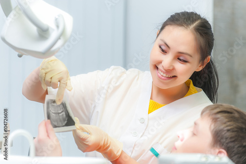 Dentist showing x-ray to a patient photo