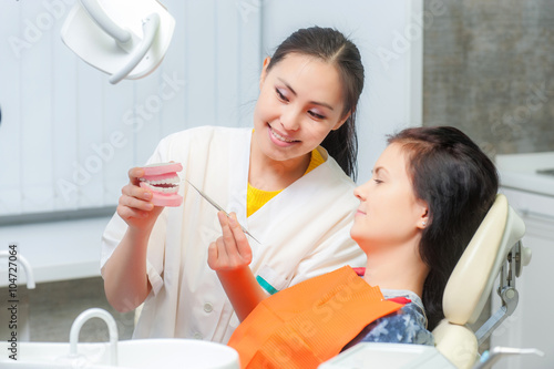 Dentist show dentures to a patient