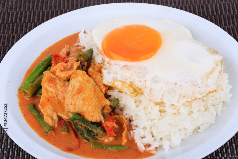 Fried pork curry, Stir fried pork and red curry paste with sunny side up egg (Moo Pad Prik Gaeng). Thai food. Fried pork curry, Stir fried pork and red curry paste with sunny side up egg (Moo Pad Prik Gaeng). Thai food.