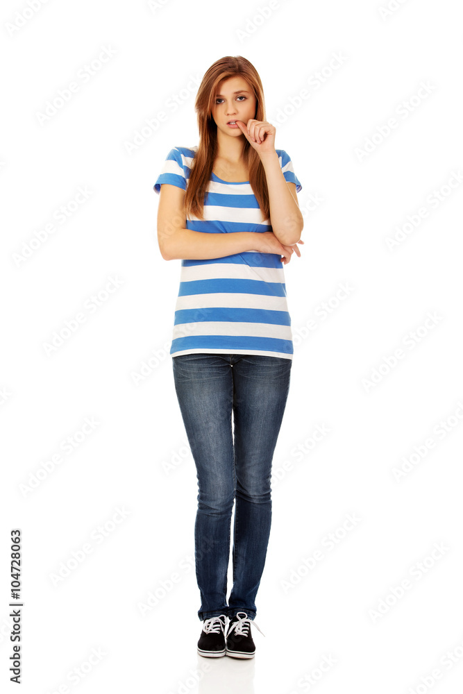 Worried teenage woman with folded arms Worried teenage woman with folded arms