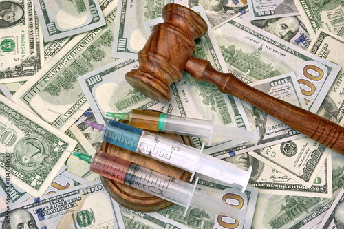 Judges Gavel And Syringe With Injection On Dollar Cash Backgroun