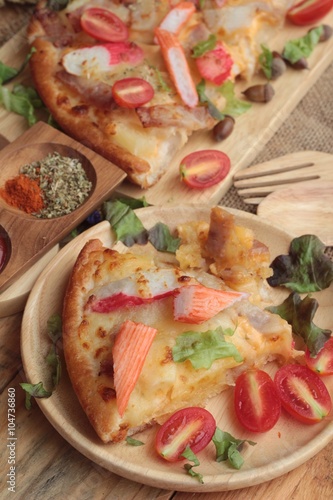Italian pizza is delicious on wood background.