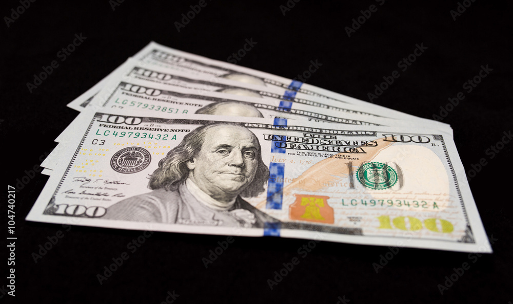 US one hundred dollars banknotes isolated on black background US one hundred dollars banknotes isolated on black background