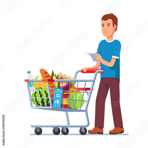 Young man pushing supermarket shopping cart