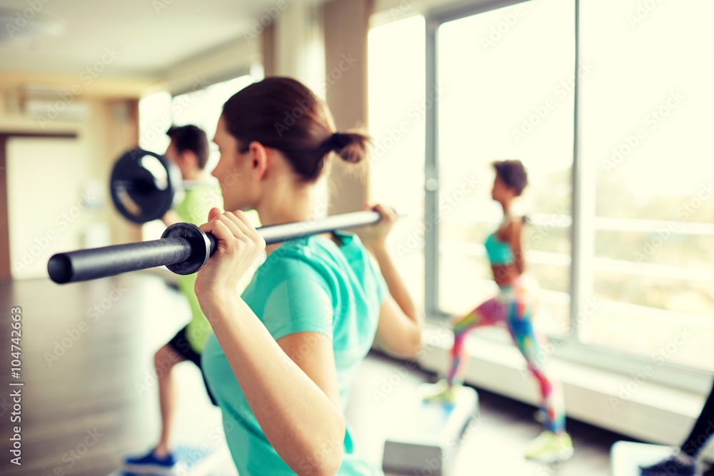 close up of people exercising with bars in gym close up of people exercising with bars in gym