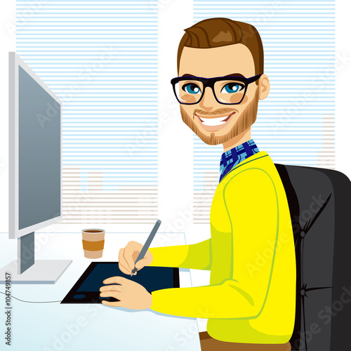Happy hipster fashion style graphic designer man working with tablet in front of computer screen