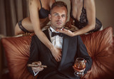 Gentleman in the company of two sexy women