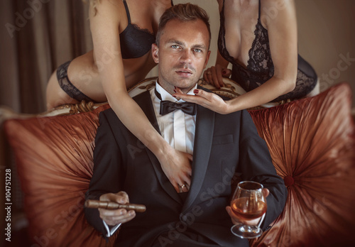 Gentleman in the company of two sexy women photo
