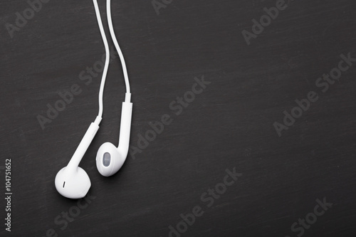 White earphones on black background