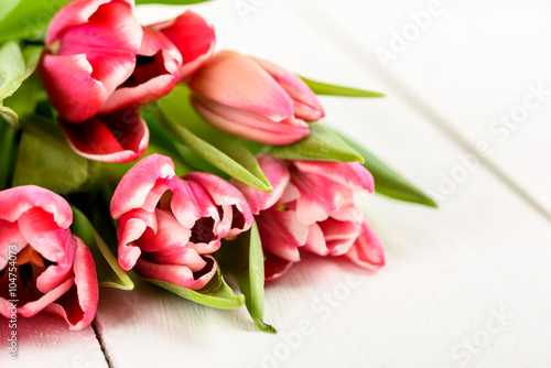 Fototapeta Naklejka Na Ścianę i Meble -  Pink Spring Tulips On White Wood Table