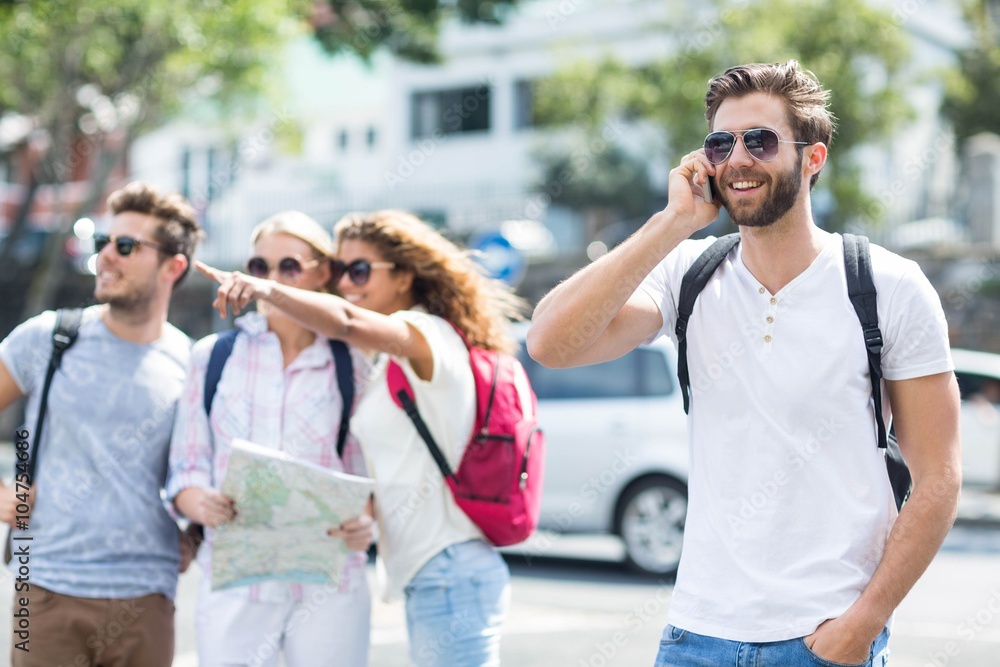 Obraz premium Hip man on phone call and friends checking map