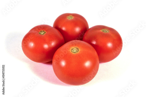 Four red tomatoes macro or close up isolated on white background