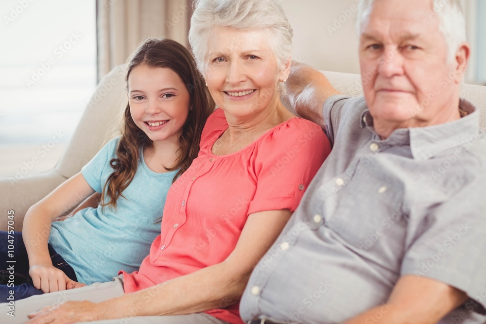 Grandparents and granddaughter sitting on sofa Grandparents and granddaughter sitting on sofa