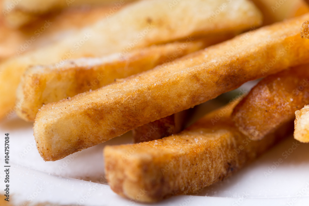 Close macro view of french fries on the plate Close macro view of french fries on the plate