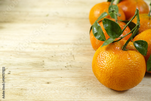 Fresh mandarin oranges fruit with green leaves copy space