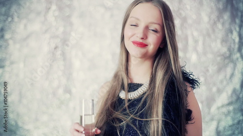 Beautiful woman holding glass with chamapagne and smiling to the camera
 photo