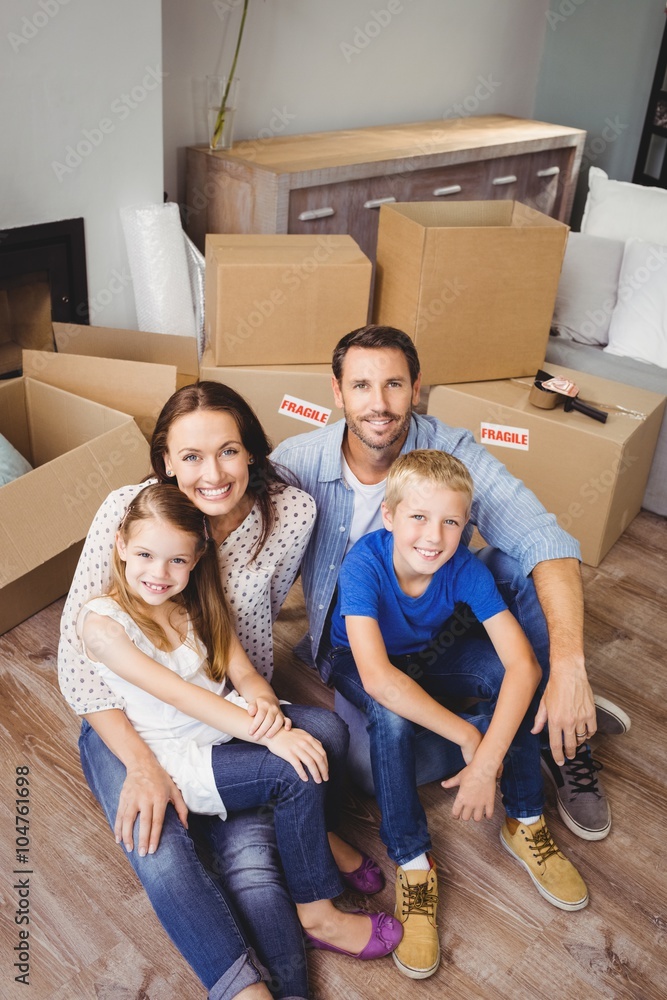 High angle portrait of smiling family with cardboard boxes High angle portrait of smiling family with cardboard boxes