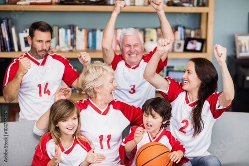 Fototapeta Naklejka Na Ścianę i Meble -  Happy family with grandparents watching basketball match