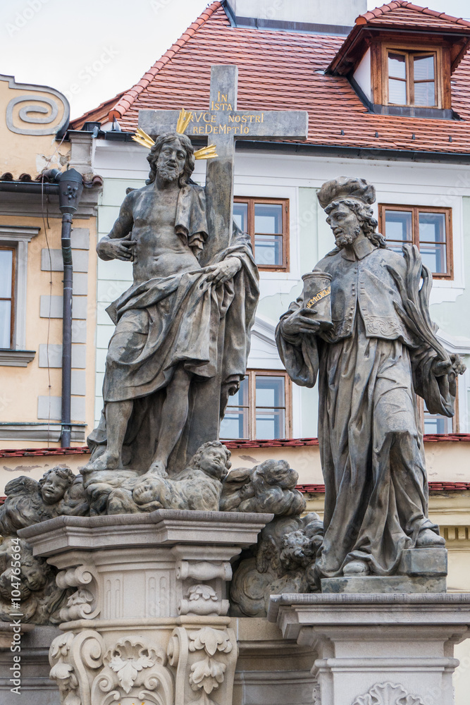 Statue of the Holy Savior with Cosmas and Damian on Charles Bridge in Prague