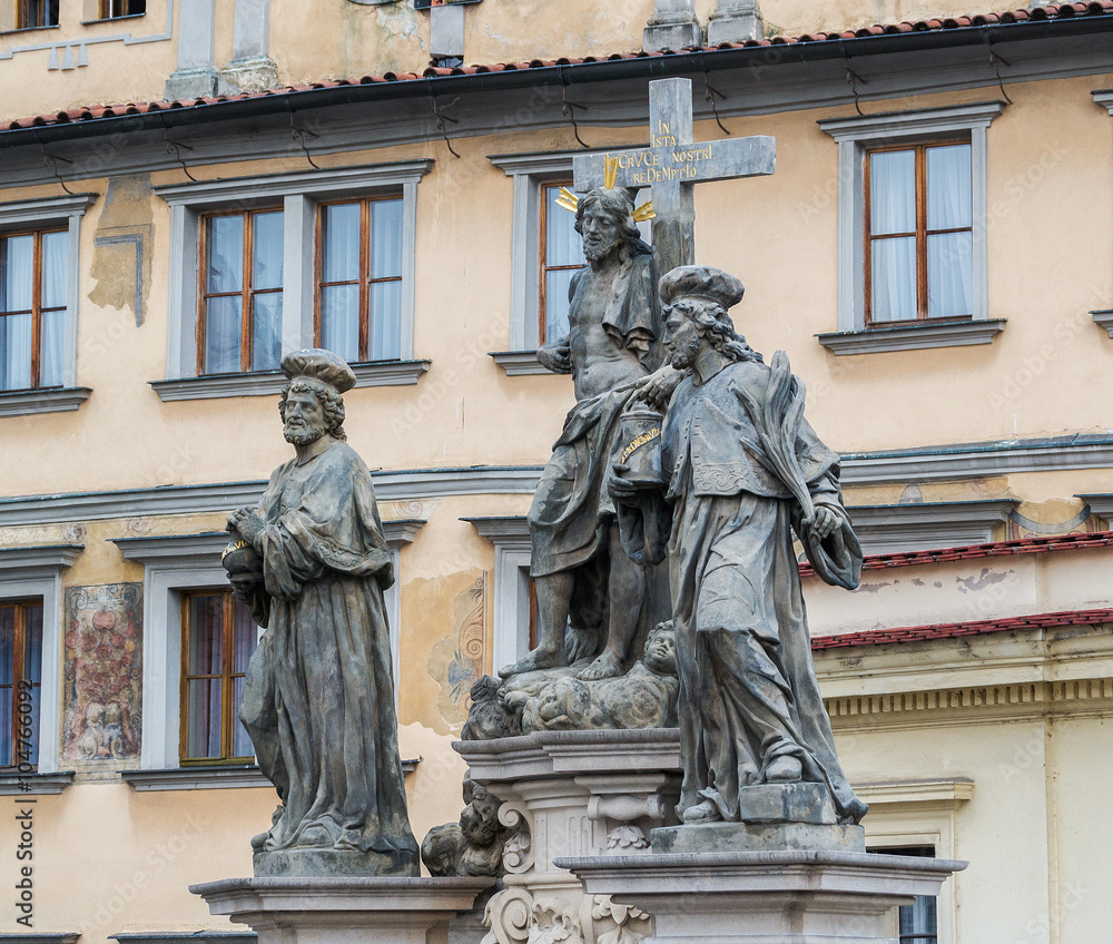 Statue of the Holy Savior with Cosmas and Damian. Text In this cross - our salvation. Charles Bridge in Prague